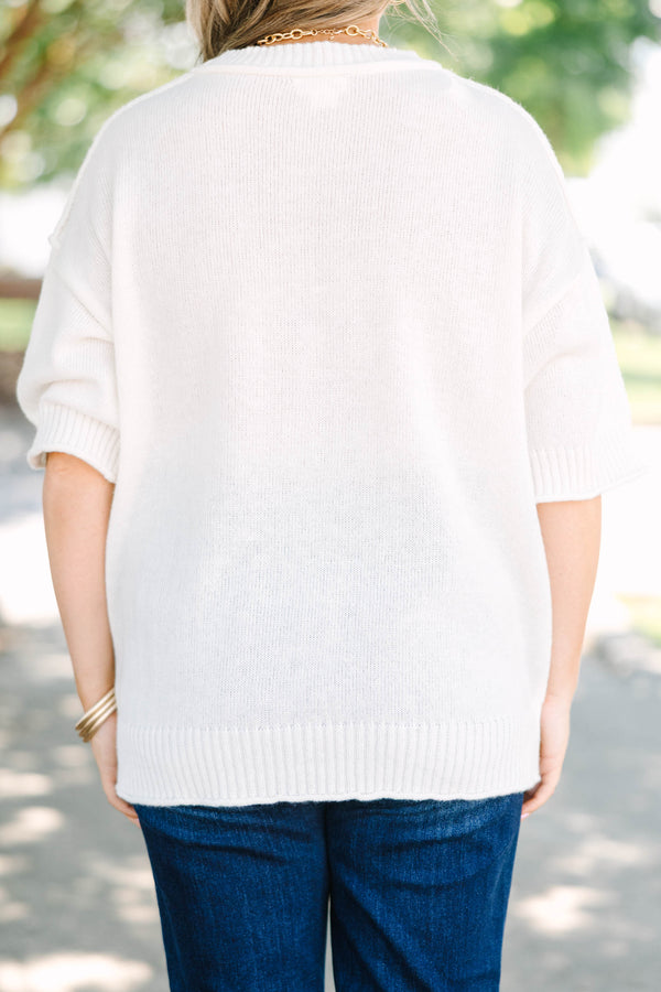 Plus size short-sleeve knit sweater top with a relaxed fit.
