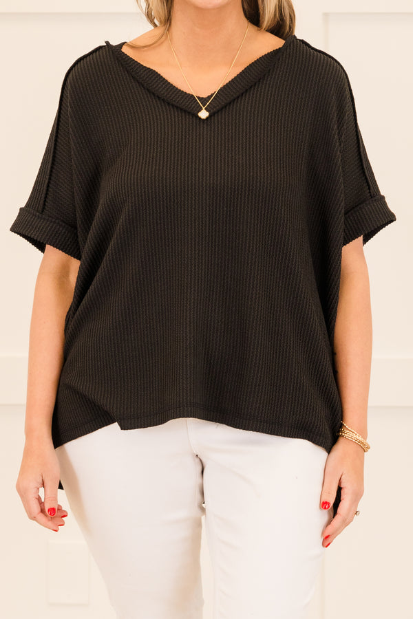 Plus Size black corded rib knit top with short sleeves, a v-neckline, and a hi-low hemline.