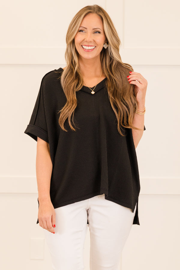 Plus Size black corded rib knit top with short sleeves, a v-neckline, and a hi-low hemline.
