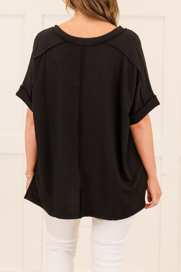 Plus Size black corded rib knit top with short sleeves, a v-neckline, and a hi-low hemline.