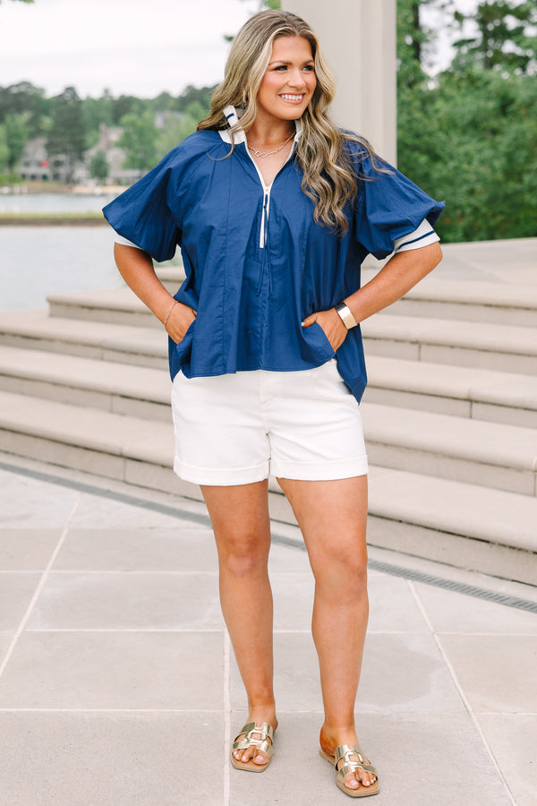 Plus Size navy blue quarter-zip top with white collar, puff sleeves, and white shorts.