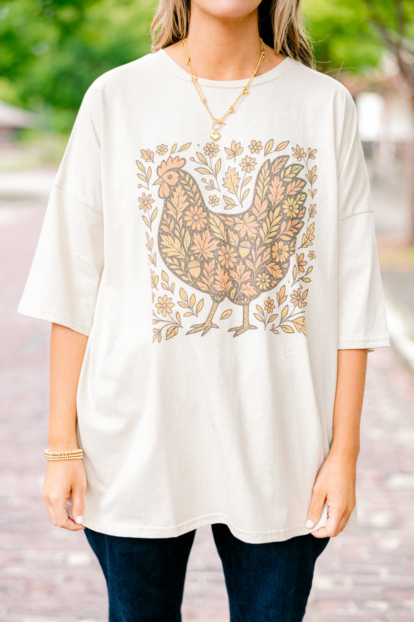 Chic Soul plus size clothing, dust colored short sleeve boyfriend tee with a turkey graphic on the center of the tee that is filled with a fall leaves pattern and also has leaves around the turkey 