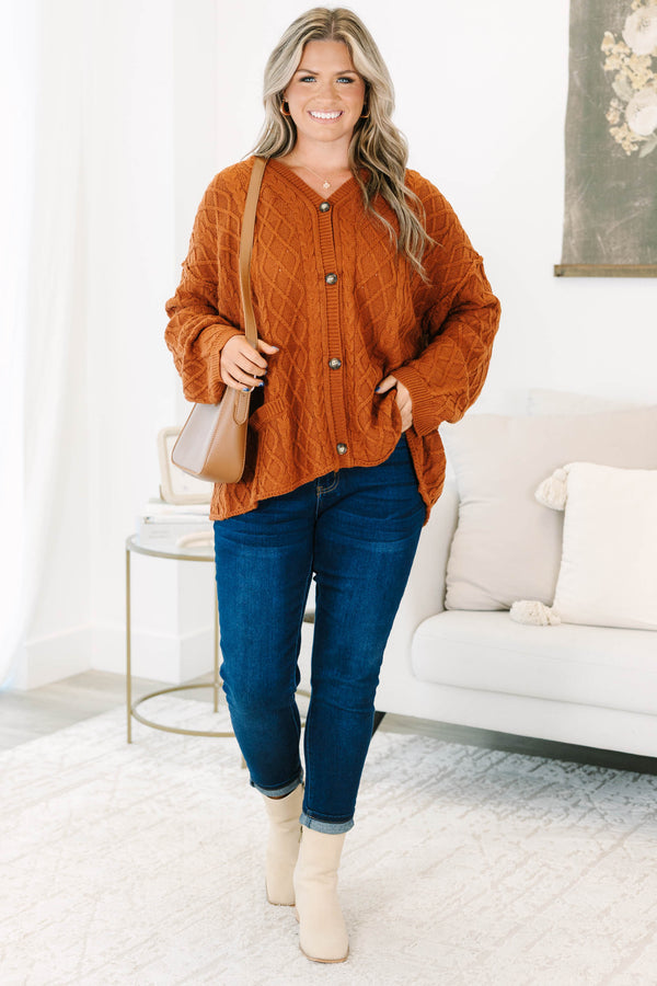 Plus Size brown cable knit cardigan with a V-neckline, button-front, and front pockets.