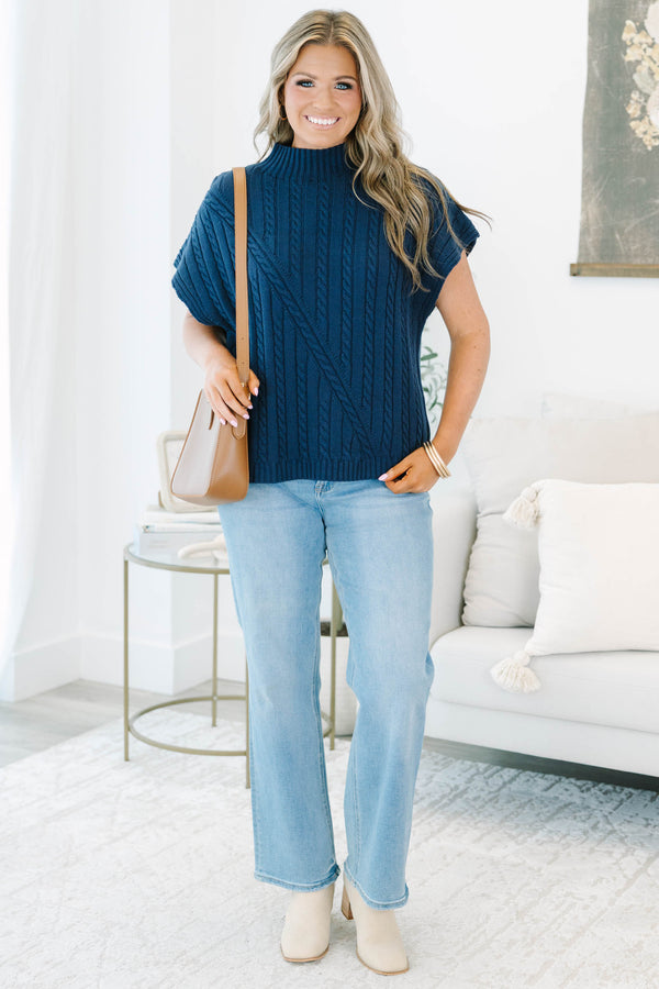 Plus size navy blue sleeveless cable-knit sweater with a mock neckline and diagonal seam detail.