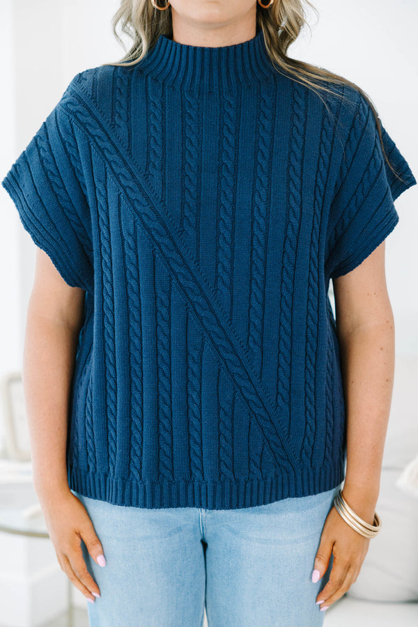 Plus size navy blue sleeveless cable-knit sweater with a mock neckline and diagonal seam detail.