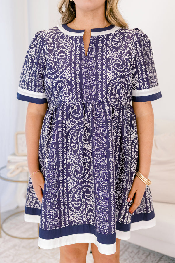 Chic Soul plus size clothing,  navy knee length dress with a paisley abstract pattern throughout the dress as well as white and navy thick stripes at the bottom of the dress around the neckline and end of each sleeve
