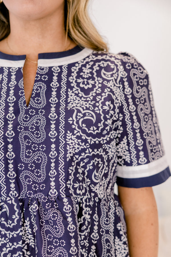 Chic Soul plus size clothing,  navy knee length dress with a paisley abstract pattern throughout the dress as well as white and navy thick stripes at the bottom of the dress around the neckline and end of each sleeve