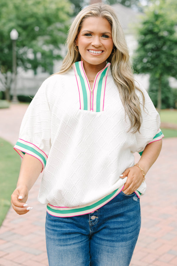 Plus size half zip top with textured fabric and pink/green contrast on hem, sleeves and neckline