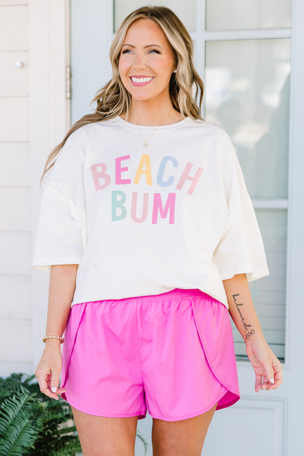 Plus Size ivory oversized boyfriend tee with colorful pastel Beach Bum graphic and crew neckline.