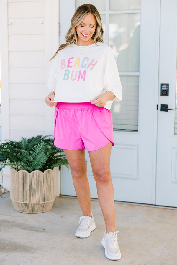 Plus Size ivory oversized boyfriend tee with colorful pastel Beach Bum graphic and crew neckline.