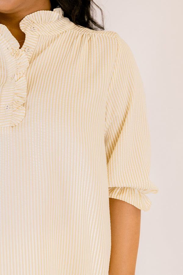 Chic Soul plus size clothing, tan striped top with half sleeves that have a ruffle on the ends of each sleeve as well as ruffle detailing along the button-up neckline
