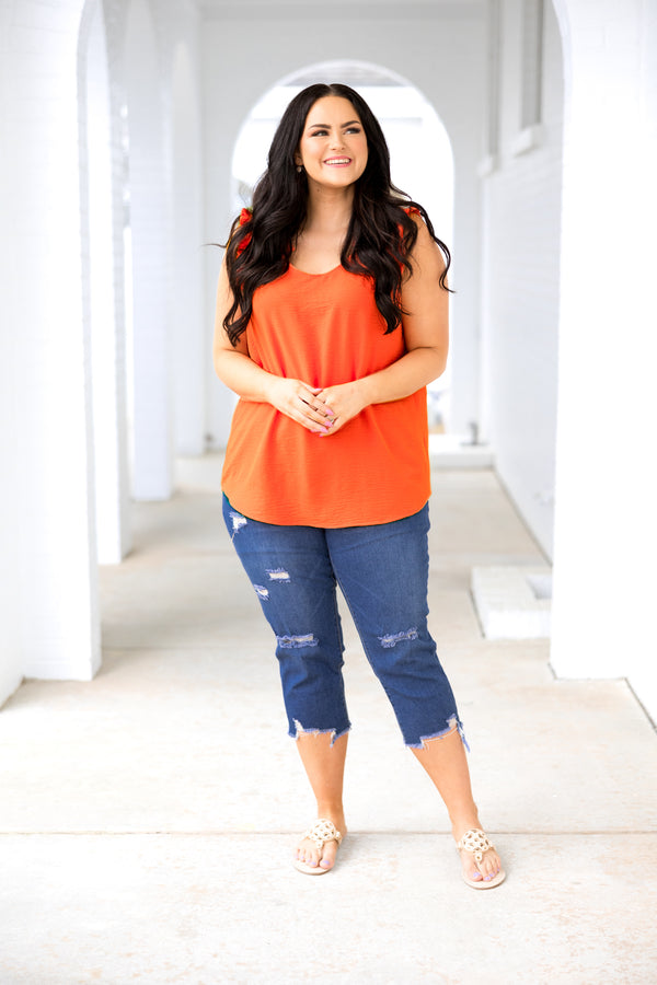 Plus Size sleeveless orange V-neck top in a textured, lightweight fabric.