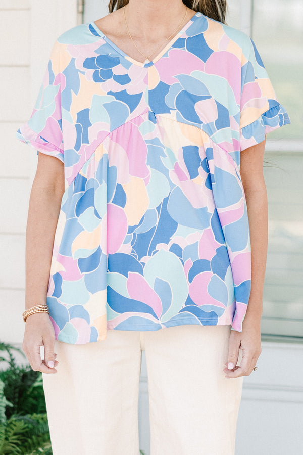 Plus Size blue abstract print babydoll top with a v-neck and short ruffled sleeves.