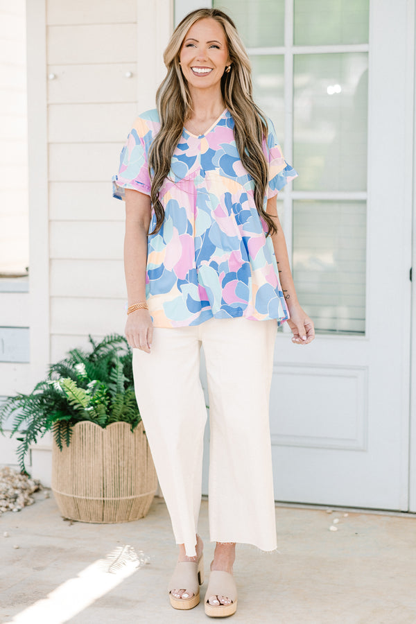 Plus Size blue abstract print babydoll top with a v-neck and short ruffled sleeves.