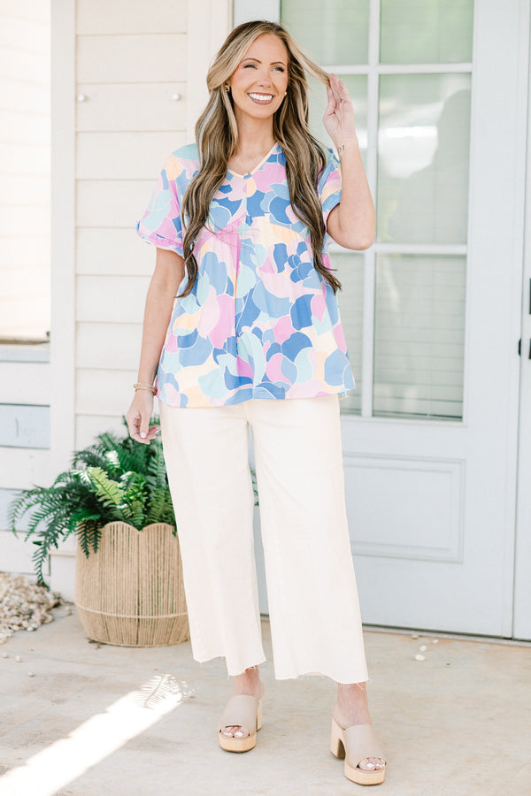 Plus Size blue abstract print babydoll top with a v-neck and short ruffled sleeves.