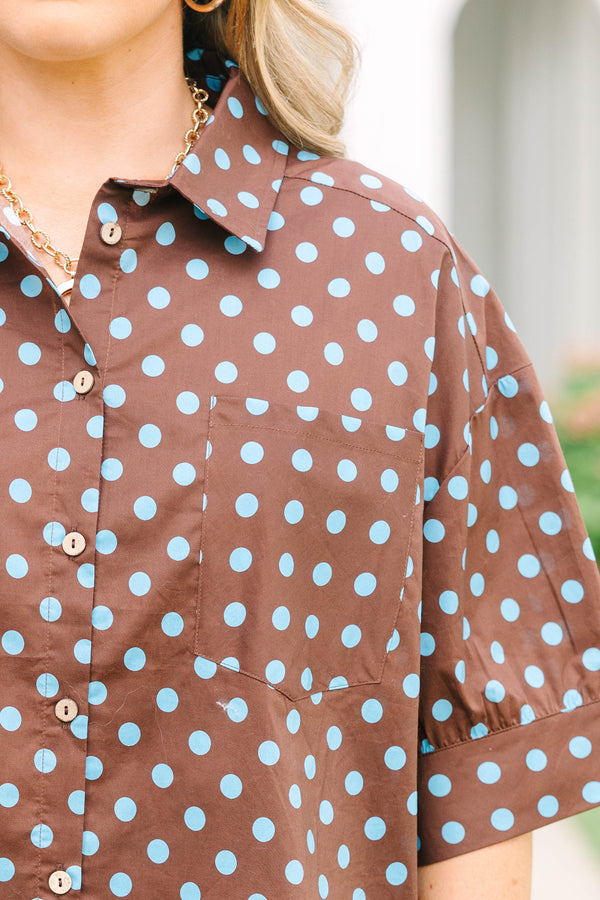 Plus Size brown button-down top with blue polka dots, short sleeves, and a ruffled hem.
