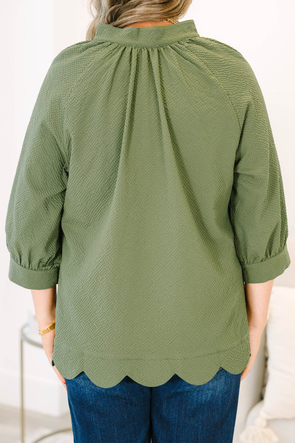 Plus Size olive textured v-neck top with three-quarter puff sleeves and a scalloped hem.