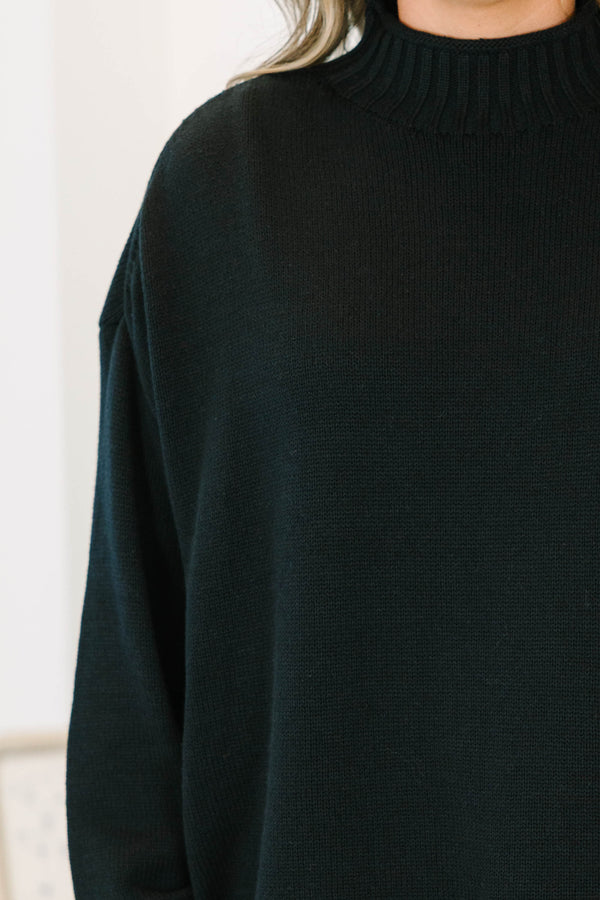 Plus Size black rollneck sweater with a relaxed fit, long sleeves, and ribbed knit details.