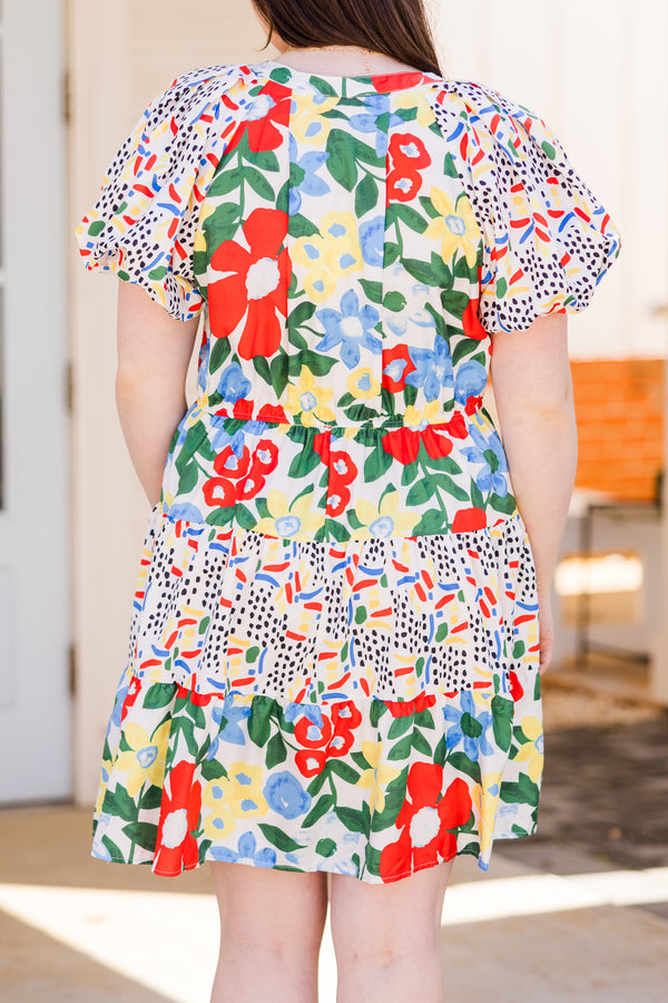 Chic Soul plus size clothing, short sleeve off white ruffled dress with small v-neckline and yellow, red, and blue patterns