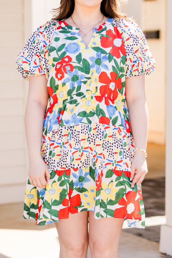 Chic Soul plus size clothing, short sleeve off white ruffled dress with small v-neckline and yellow, red, and blue patterns