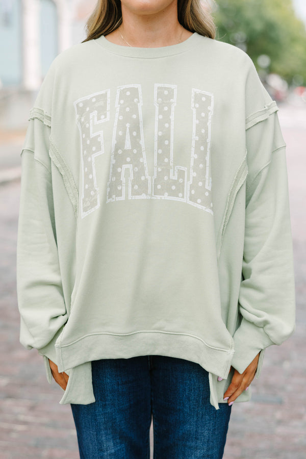 Plus Size light sage crew neck sweatshirt with a white polka dot 'FALL' graphic and raw seam detail.