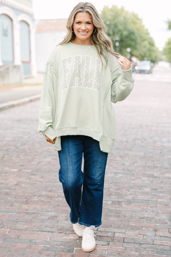 Plus Size light sage crew neck sweatshirt with a white polka dot 'FALL' graphic and raw seam detail.