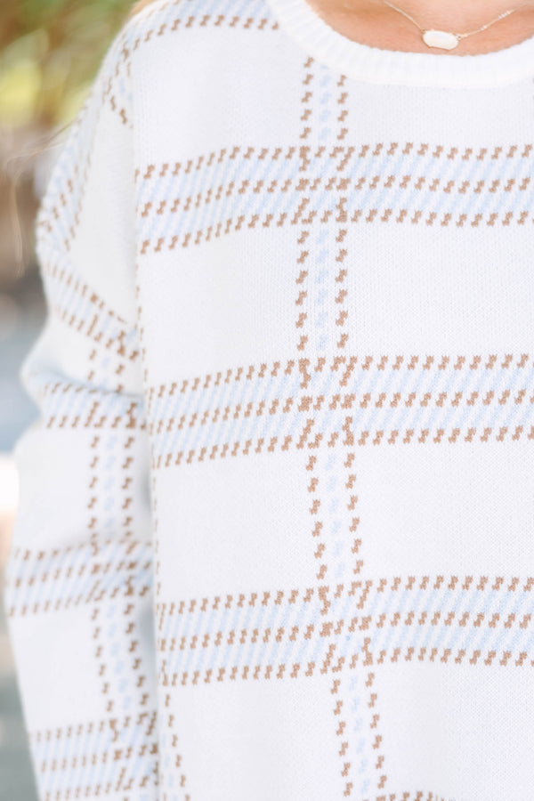 Plus Size ivory crewneck sweater with a tan and blue plaid pattern and long sleeves.