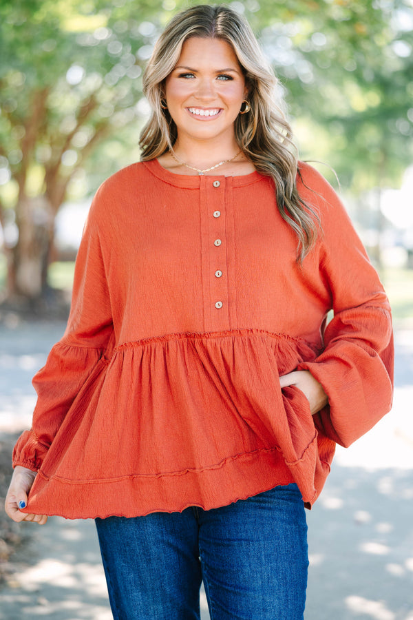 Plus Size rust-colored babydoll top with long puff sleeves, a button-down front, and textured fabric.