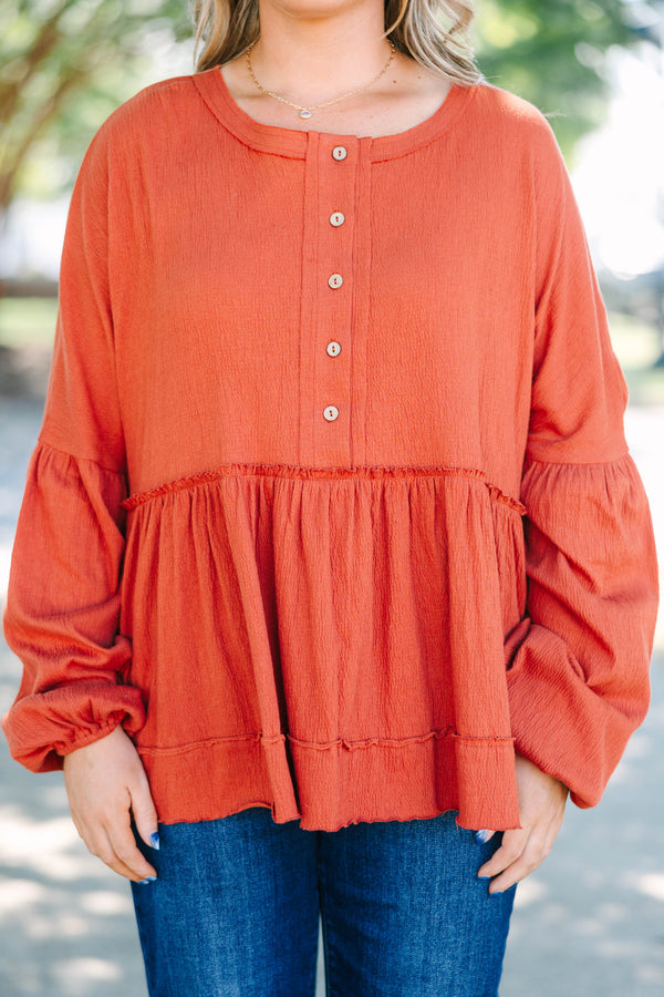 Plus Size rust-colored babydoll top with long puff sleeves, a button-down front, and textured fabric.