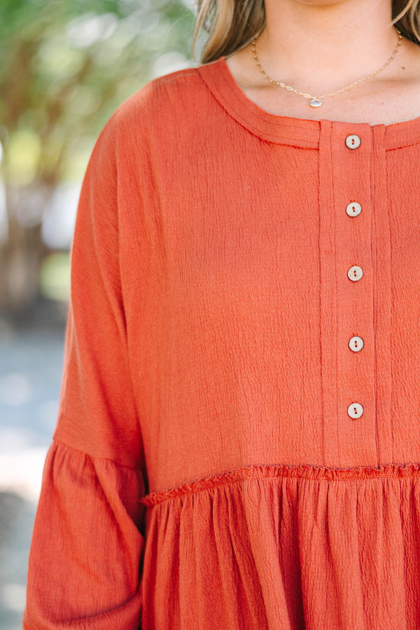 Plus Size rust-colored babydoll top with long puff sleeves, a button-down front, and textured fabric.