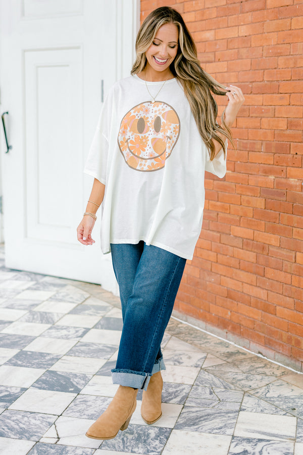 Chic Soul Plus size Clothing, Ivory Short Sleeve tee with a black smiley face on the center of the shirt that is filled with an orange floral design 
