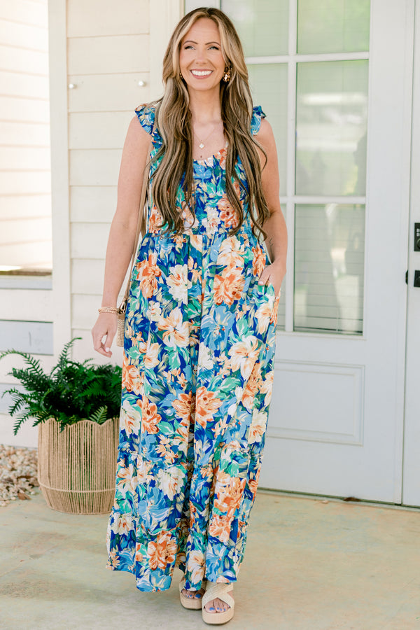 Chic Soul plus size clothing, flutter strap navy blue flowy jumpsuit with wide-legs and a orange and blue floral pattern