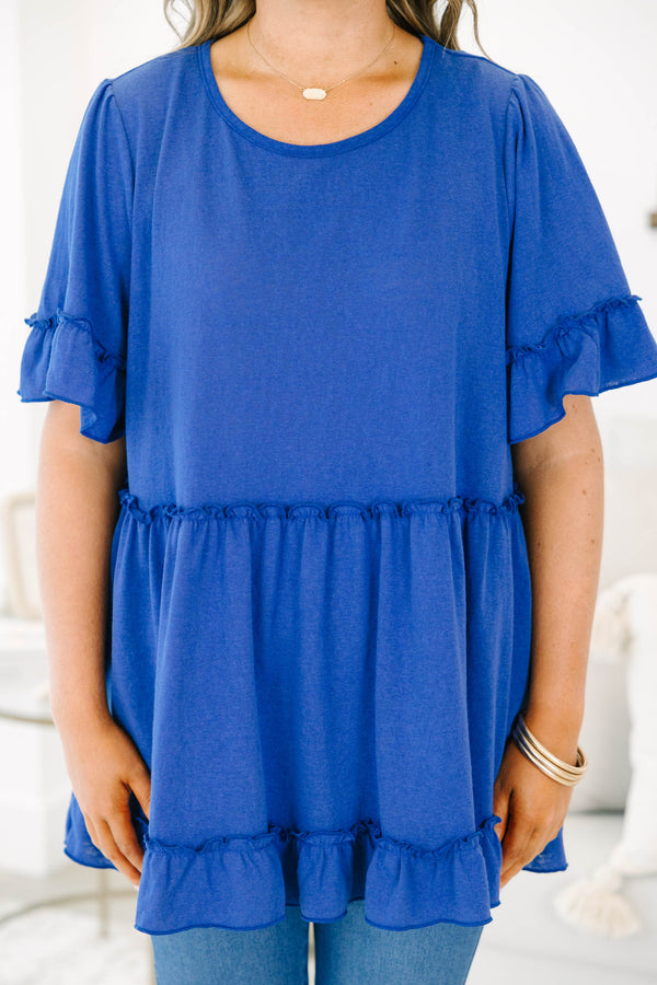 Plus size blue flowy top with ruffle sleeves and a tiered babydoll silhouette in a soft cotton blend
