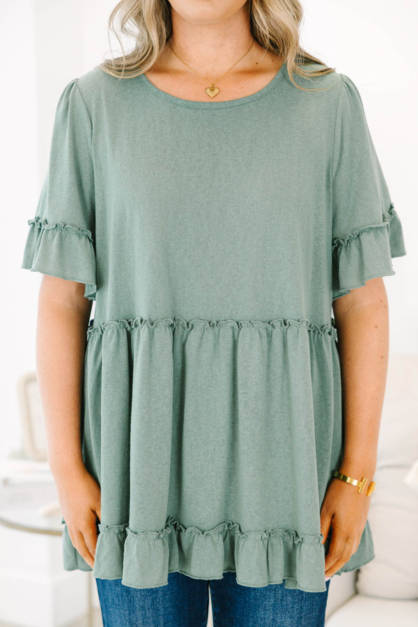 Plus size dusty green babydoll top with ruffle sleeves and hemline
