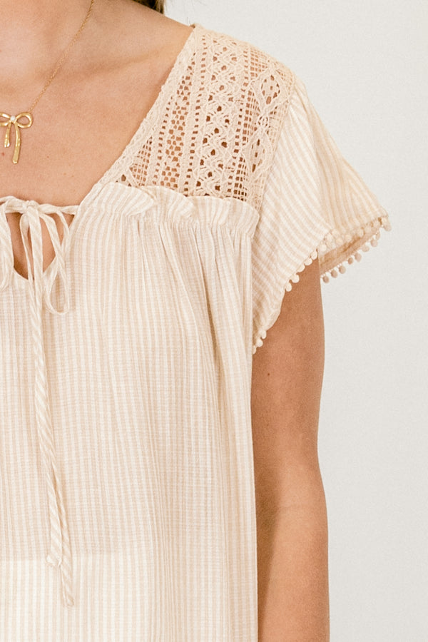 Chic Soul plus size clothing, thin light khaki vertically striped flutter sleeve casual top with lace detailing on the shoulders and a string tie neckline and pompom trim on the sleeves