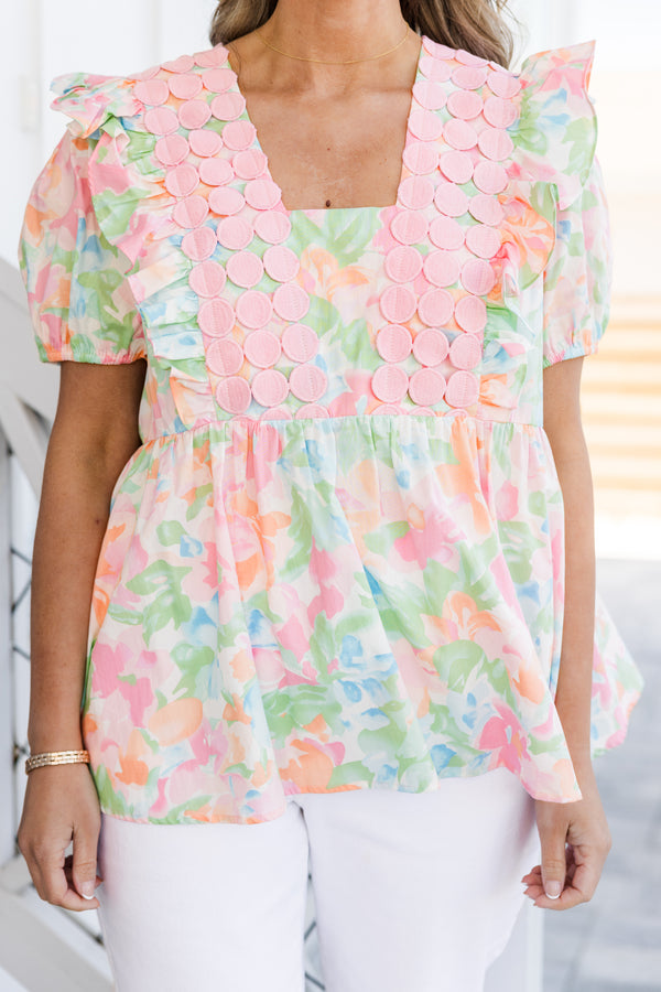 Chic Soul plus size clothing, short-puffed-sleeve pink watercolor baby doll top with a square-neckline and a pink spotted fabric layered on top of the neckline with a subtle watercolor floral pattern 