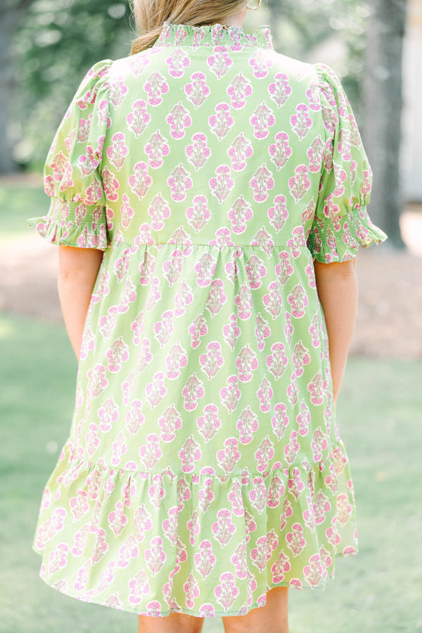 Plus Size green floral mini dress with pink trim, V-neckline, and short puff sleeves.