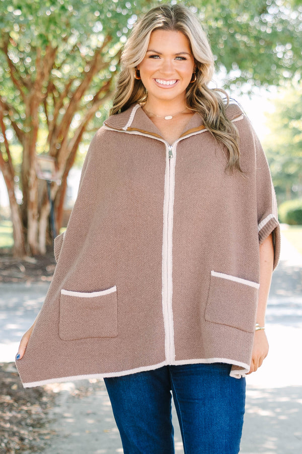 Plus Size brown zip-up knit poncho sweater with white trim, front pockets, and a wide collar.
