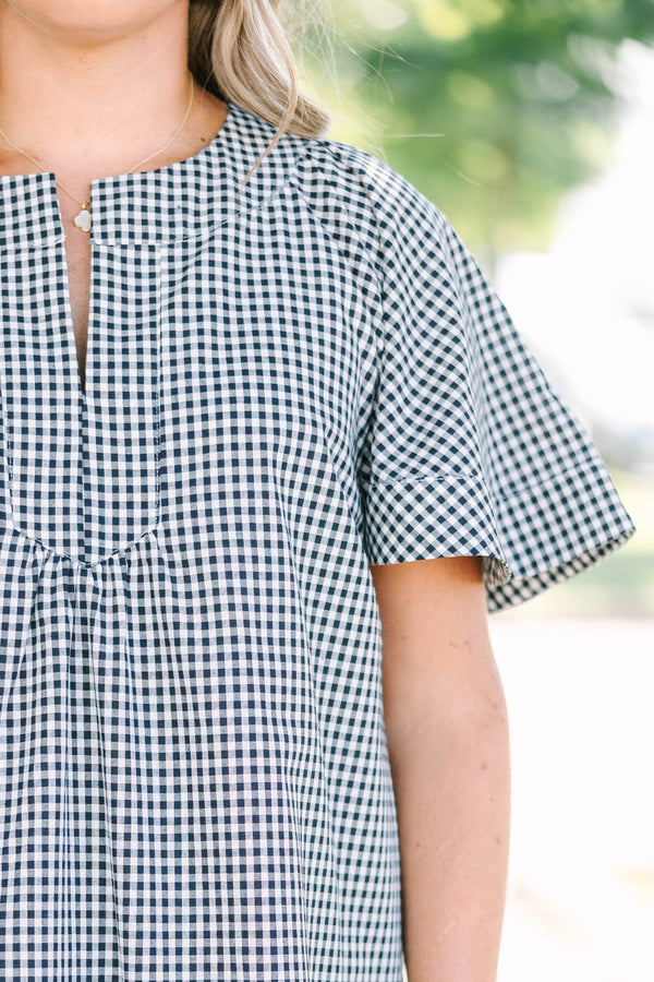 Plus Size black and white gingham dress with a split v-neckline and short flutter sleeves.