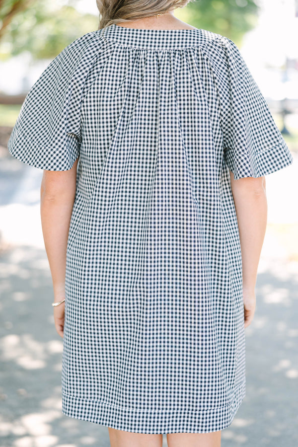 Plus Size black and white gingham dress with a split v-neckline and short flutter sleeves.