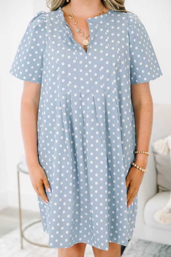 Plus Size blue polka dot dress with short puff sleeves, a V-neckline, and a flowy pleated skirt.