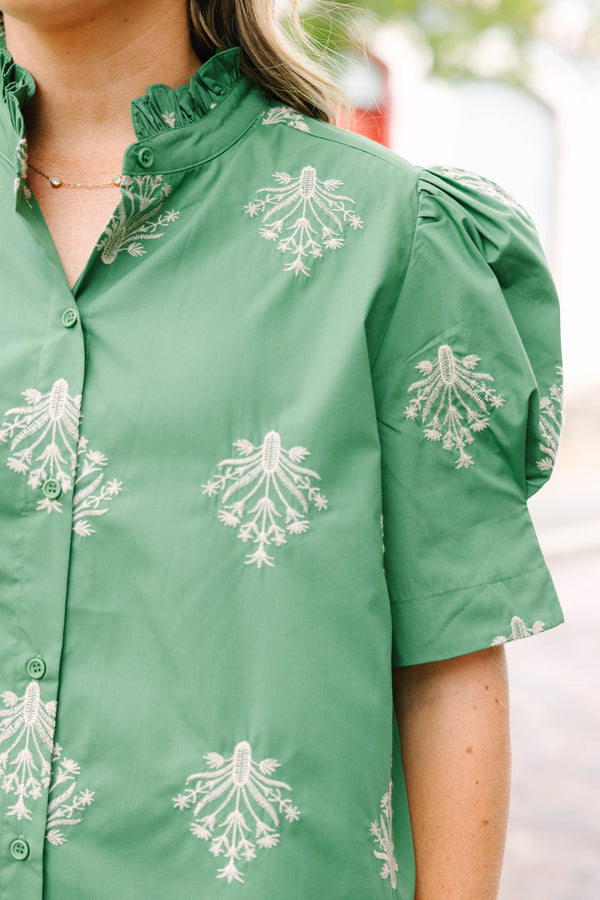 Plus Size olive green blouse with embroidered floral print, puff sleeves, and a ruffled mock neck.