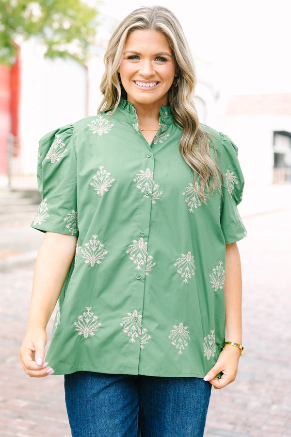 Plus Size olive green blouse with embroidered floral print, puff sleeves, and a ruffled mock neck.