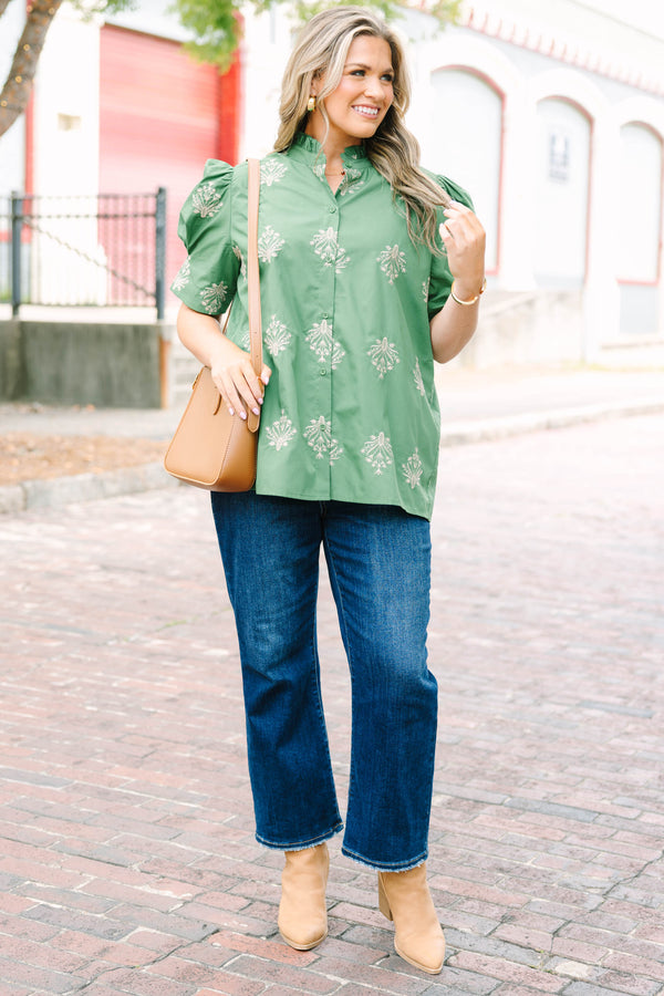 Plus Size olive green blouse with embroidered floral print, puff sleeves, and a ruffled mock neck.