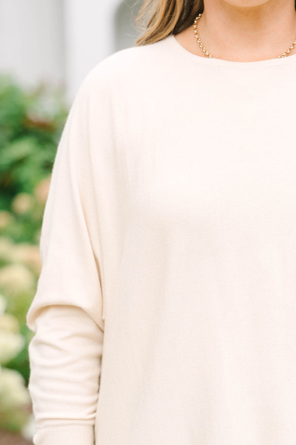 Plus Size beige relaxed fit knit sweater with a round neckline and button-cuffed long sleeves.