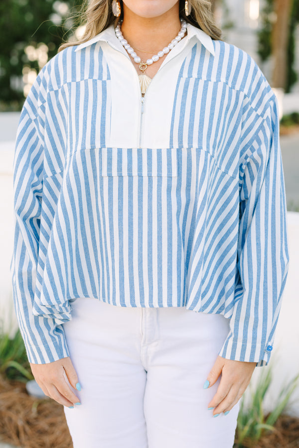 Chic Soul plus size clothing, blue striped top with a zipper detail on the chest outlined by solid white blocking around the neckline and the zipper.
