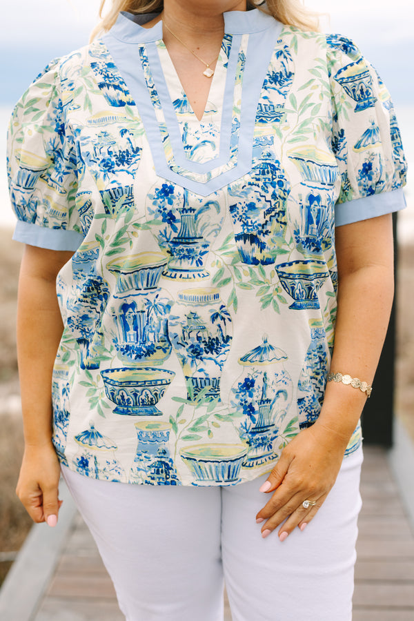 Chic Soul plus size clothing, blue top with a chinoiserie printed pattern throughout and light blue cuffs at the end of each sleeve and along the v-neckline 