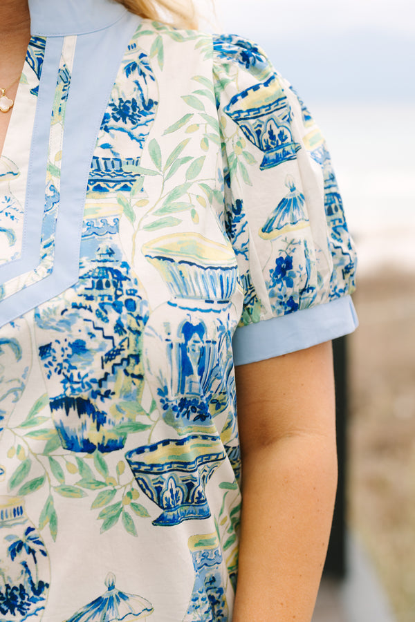 Chic Soul plus size clothing, blue top with a chinoiserie printed pattern throughout and light blue cuffs at the end of each sleeve and along the v-neckline 