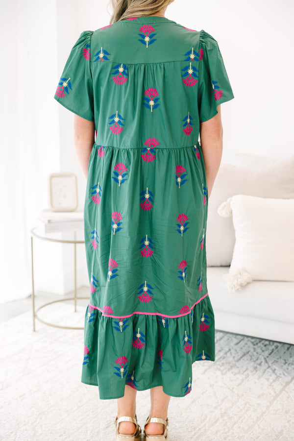 Plus size hunter green midi dress with pink floral embroidery, flowy fit, and tiered ruffle hem.