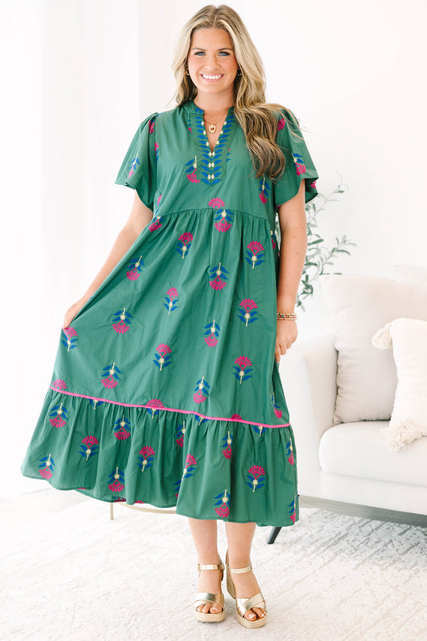 Plus size hunter green midi dress with pink floral embroidery, flowy fit, and tiered ruffle hem.